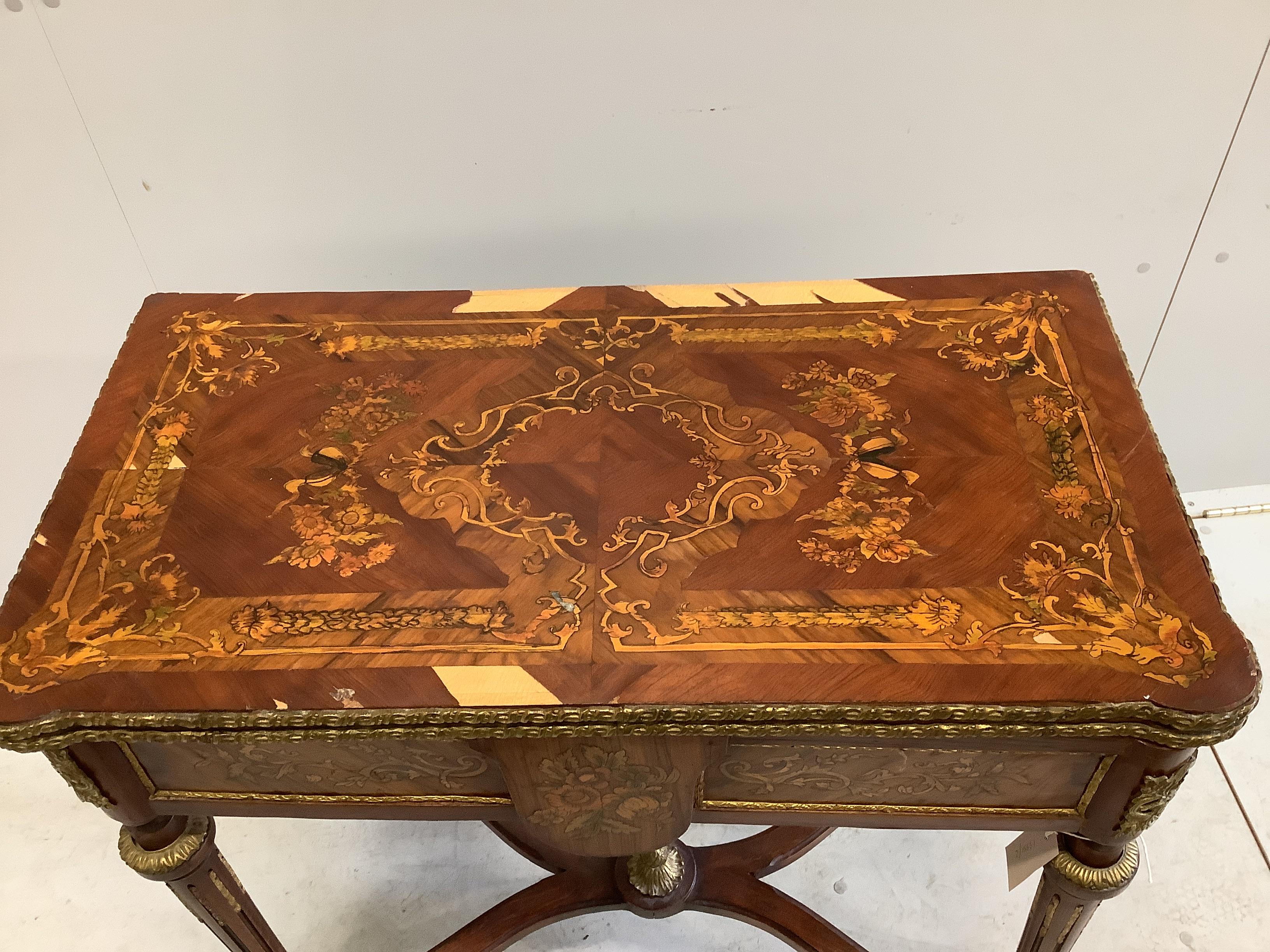 A Louis XVI style gilt metal mounted and marquetry inlaid folding card table, width 77cm, depth 40cm, height 78cm